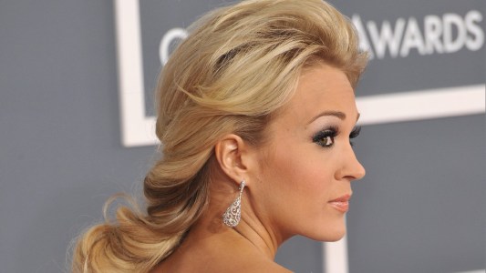 Carrie Underwood wears a white dress on the red carpet