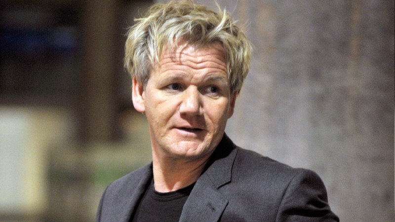 Gordon Ramsay wears a dark suit jacket at LAX airport