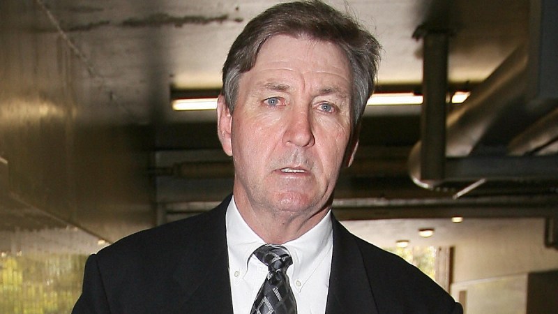 Jamie Spears wears a dark suit outside of a courthouse