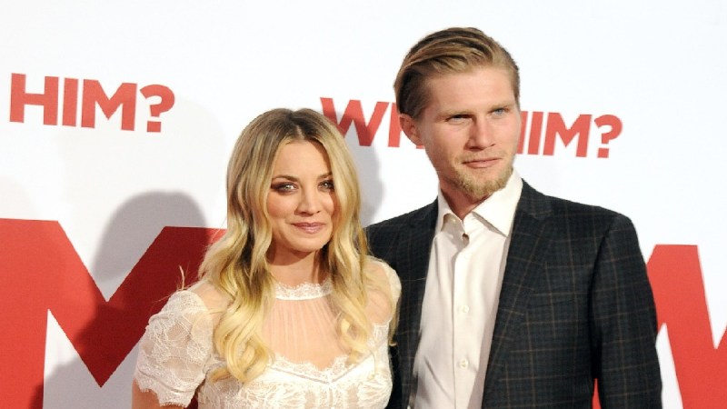 Kaley Cuoco stands with Karl Cook on the red carpet