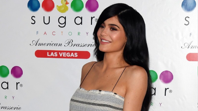Kylie Jenner wears a black and white stripped dress on the red carpet