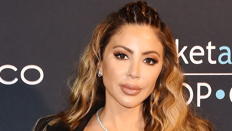 Larsa Pippen wears a black top and pants on the red carpet