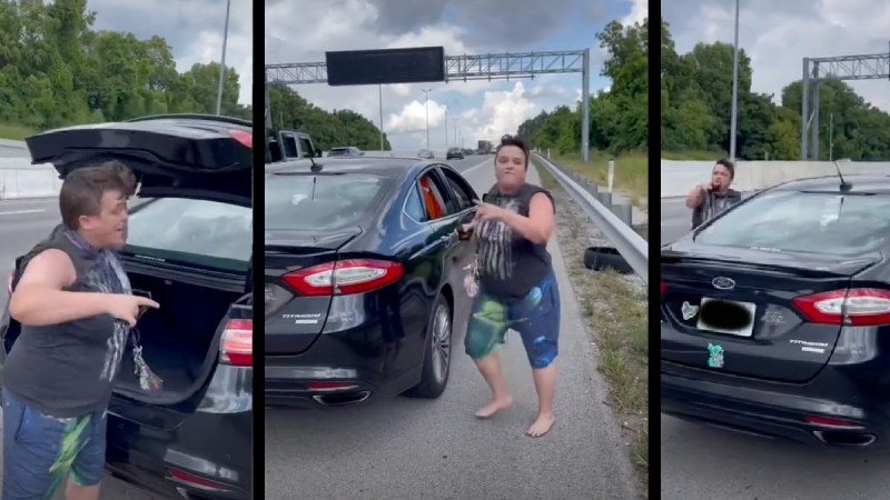 A Lyft driver wearing a black top and shorts stands by her car on the side of a Nashville highway