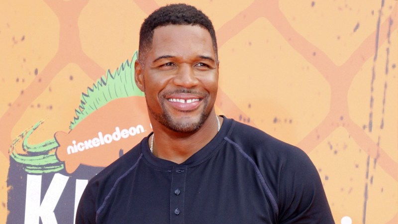 Michael Strahan wears a black top on the red carpet