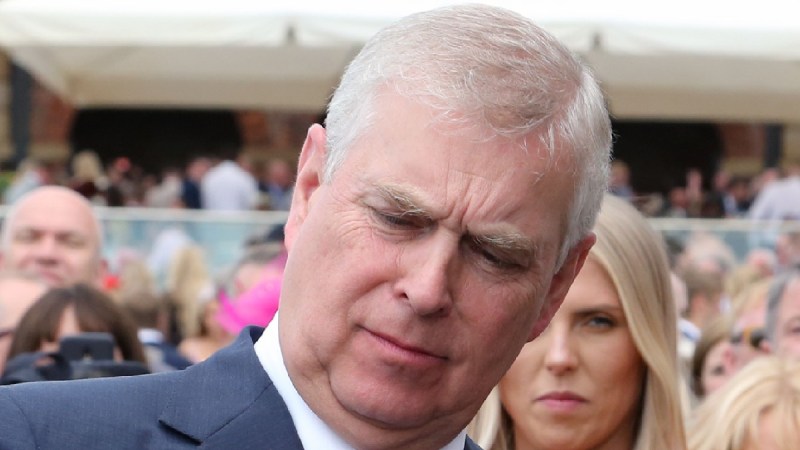 Prince Andrew examines a small bag at a royal event