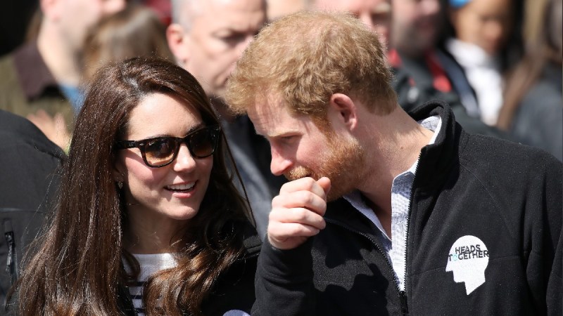 Kate Middleton and Prince Harry wear matching black jackets at an outdoor royal event