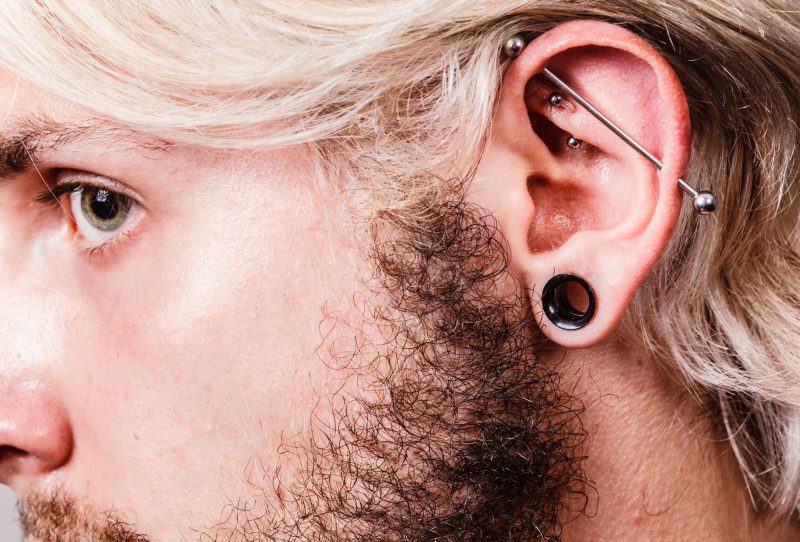Profile of man with an industrial piercing.
