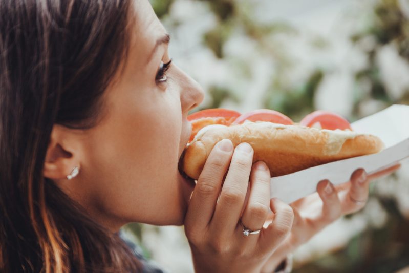 Image of woman eating hotdog
