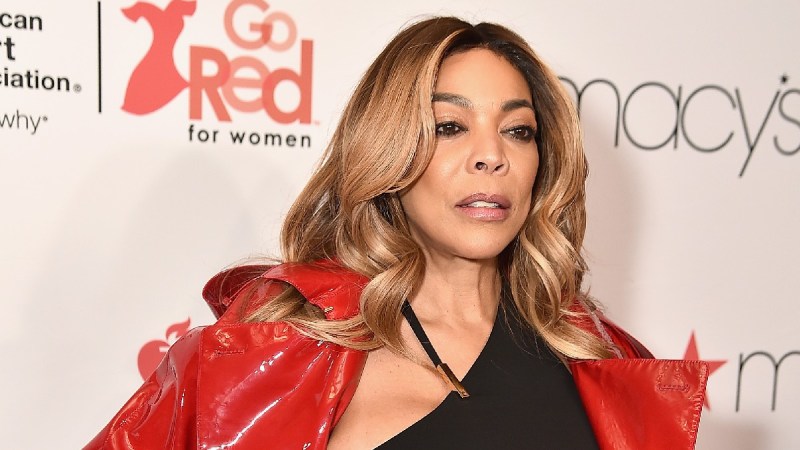 Wendy Williams wears a red jacket over a black dress on the red carpet