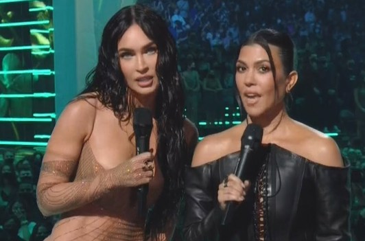 Screenshot of Megan Fox on the left, Kourtney Kardashian on the right, presenting at the 2021 VMAs on MTV