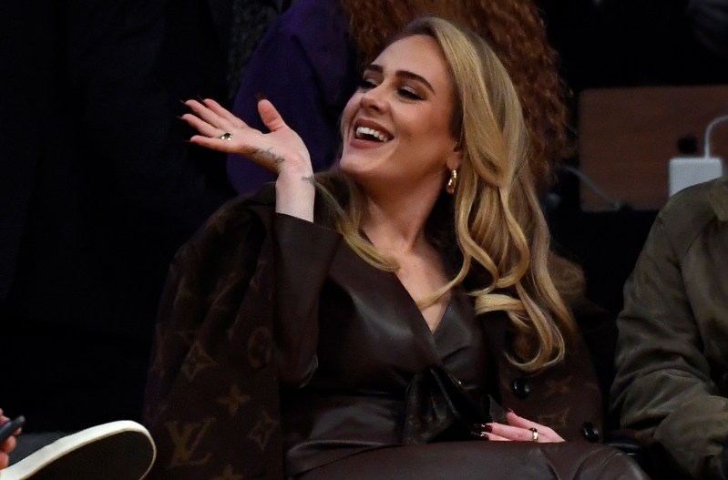 Adele waving in a Louis Vuitton coat.