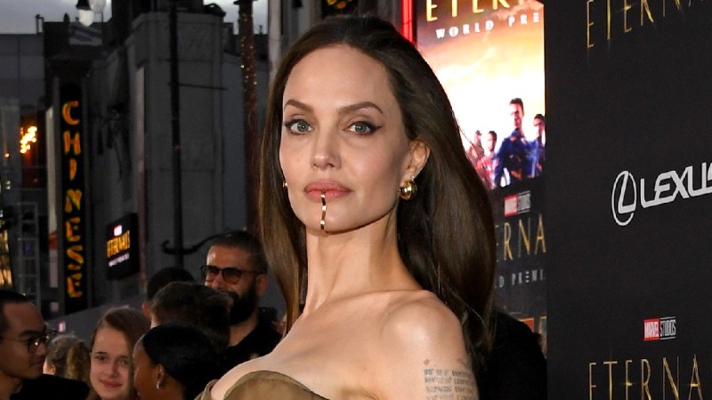Angelina Jolie wears a brown, strapless dress on the Eternals red carpet