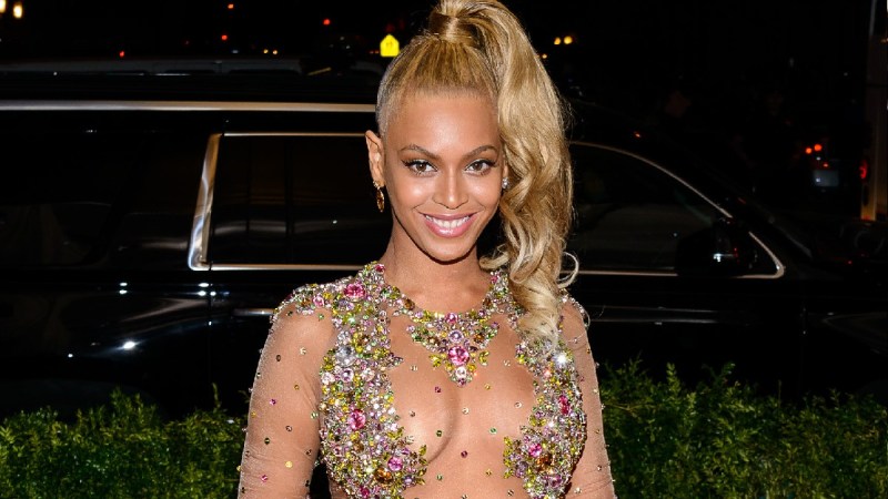 Beyonce wears a sheer gown with colorful jewel accents to the Met Gala