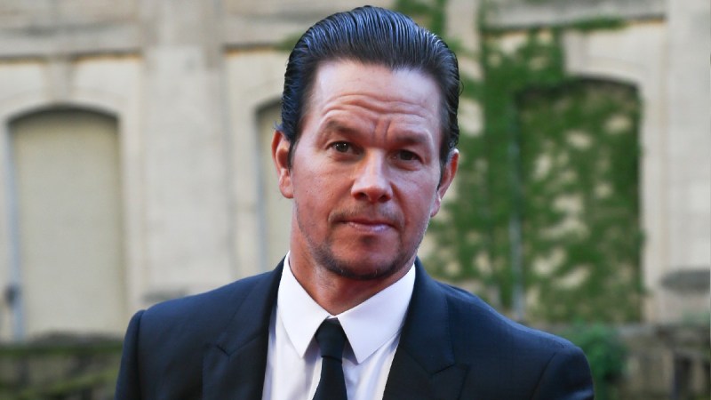 Mark Wahlberg wears a black suit to a movie premiere