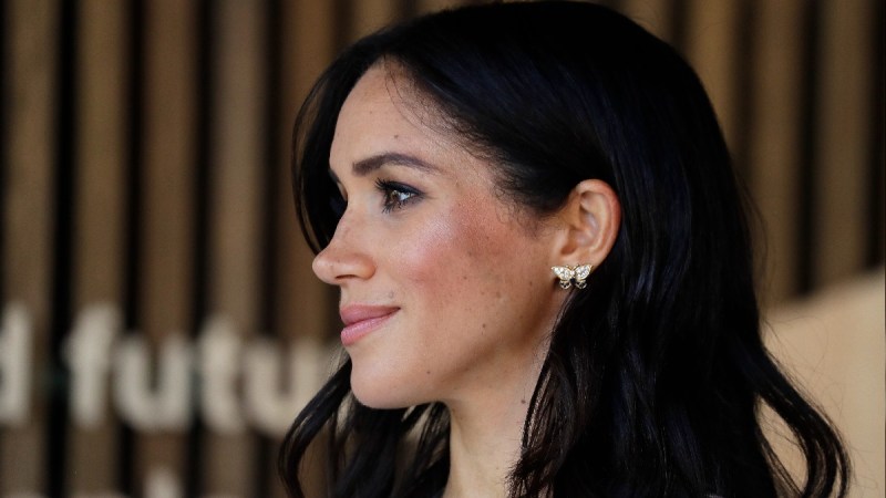 Meghan Markle looks forward as the camera catches her profile and butterfly earing