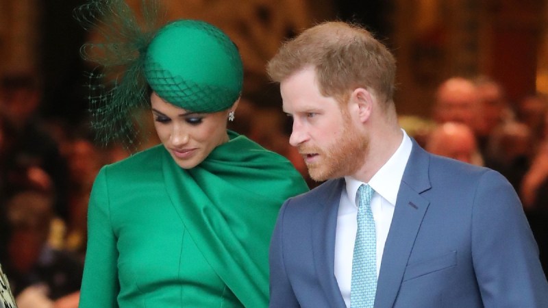 Meghan Markle, in green, walks beside husband Prince Harry outside of a London church