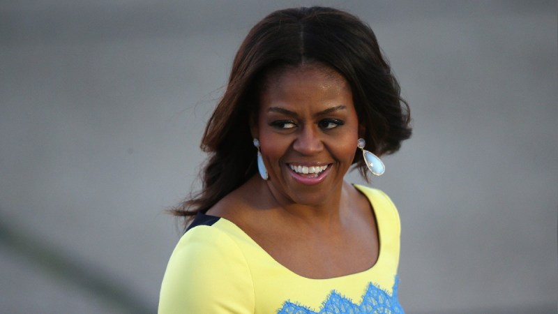 Michelle Obama wears a yellow and blue dress during a visit to London, England