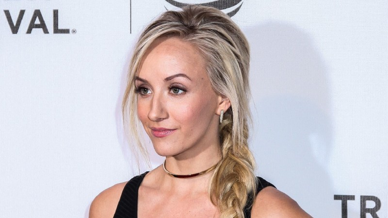 Nastia Liukin wears a black top and red bottoms on the red carpet
