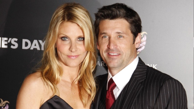 Jillian Fink and Patrick Dempsey, both dressed in black, pose on the red carpet