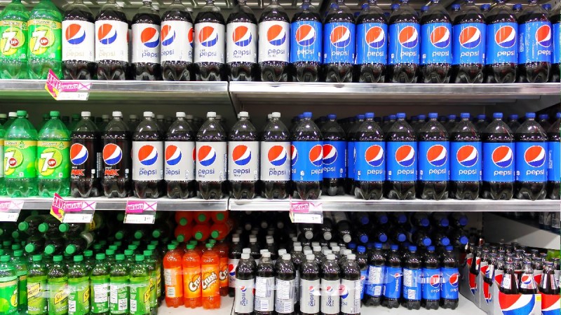 Bottles of PepsiCo sodas sit on a grocery store shelf