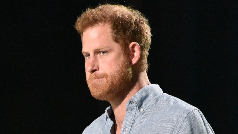 Prince Harry wears a blue shirt while making remarks onstage