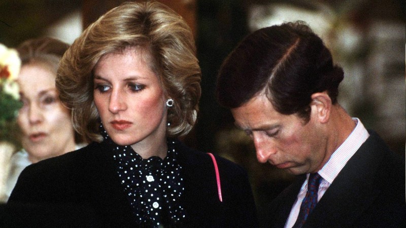 Princess Diana wears dark maternity clothes as she stands near then-husband Prince Charles, in a dark suit