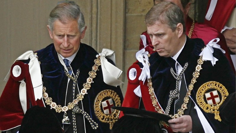 Prince Charles and Prince Andrew wear red, black and white ceremonial robes at Windsor Castle