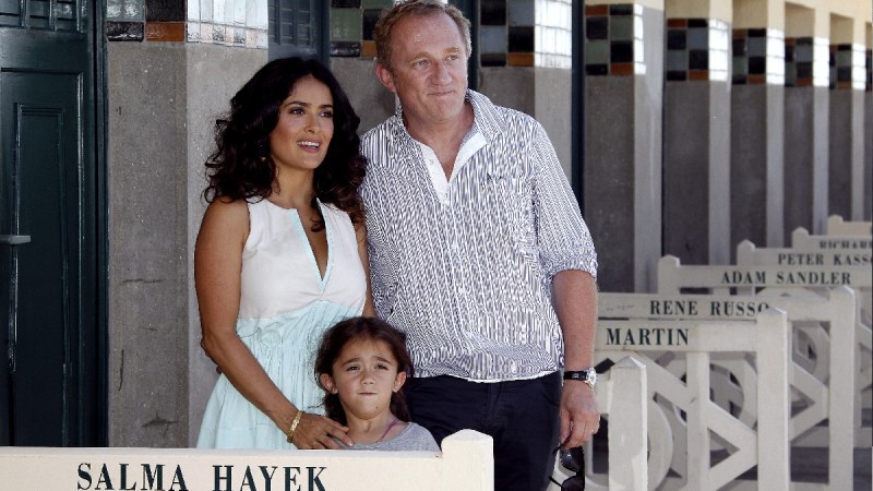 Salma Hayek poses alongside husband Francois-Henri Pinault and daughter Valentina outdoors