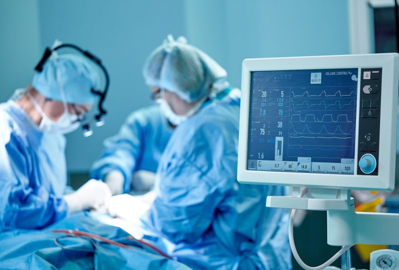 Surgeons operating on a patient.