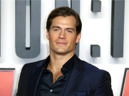 Henry Cavill looks dashing in a dark blue suit