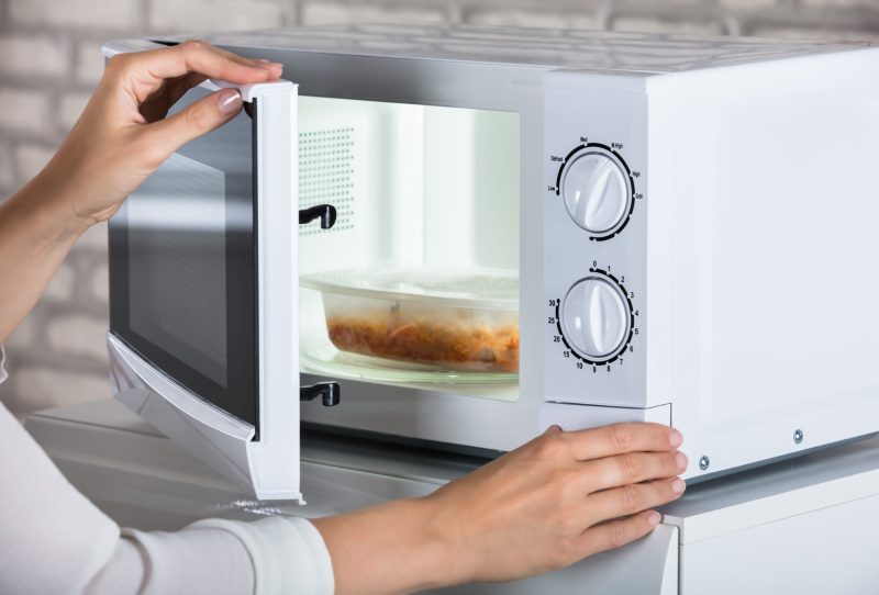 Person using a microwave.