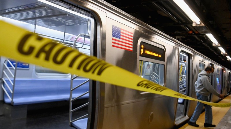 A photo of a New York subway with yellow caution tape in the foreground
