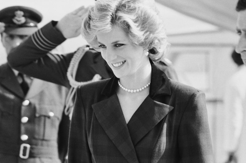 A black and white photo of Princess Diana in a stylish outfit