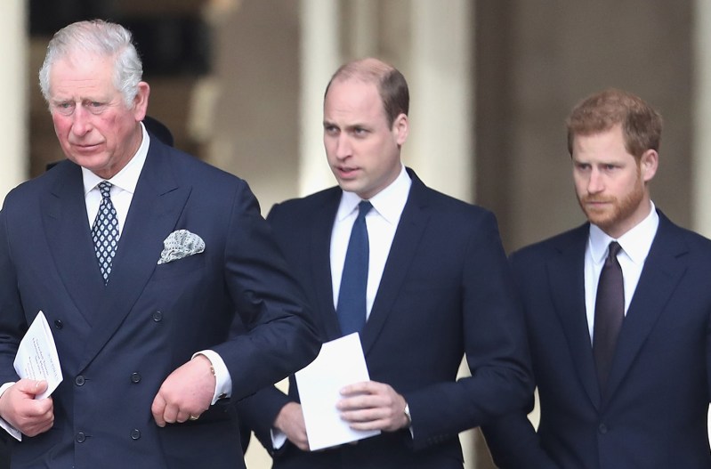 From left to right: Prince Charles, Prince William, Prince Harry all in suits.