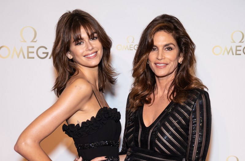 Kaia Gerber smiling on the left with her mother Cindy Crawford on the right