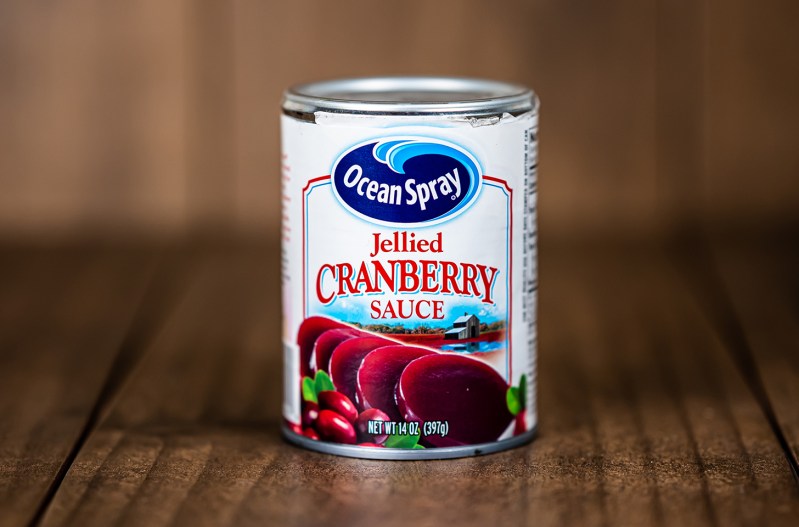 A can of Ocean Spray cranberry sauce on a wood table.