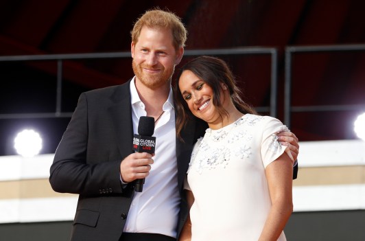 Prince Harry with his arm around Meghan Markle