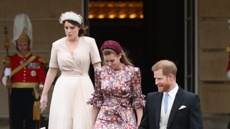 Princesses Eugenie and Beatrice walk with Prince Harry down stairs