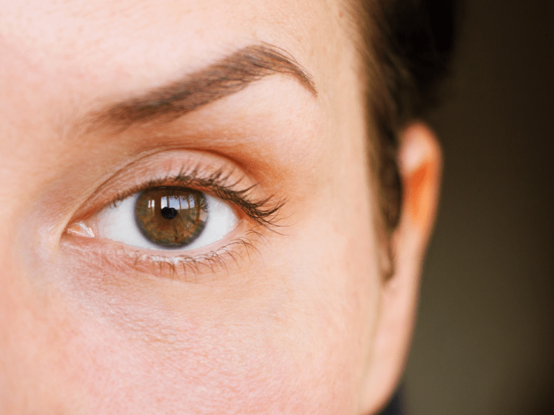 A close up of a woman arching her eyebrow