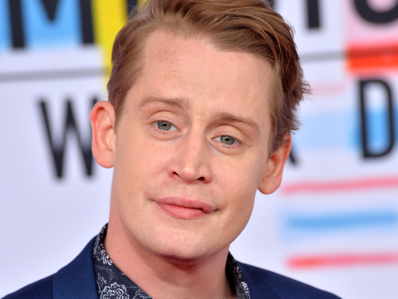 Macauley Culkin smiling on the red carpet