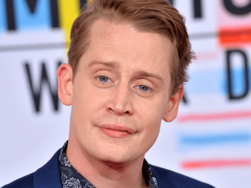 Macauley Culkin smiling on the red carpet