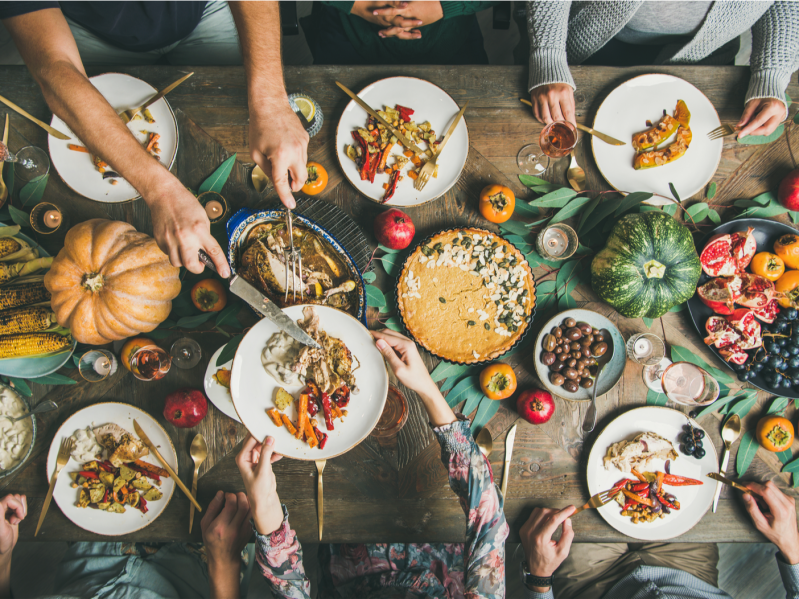 Bustling Thanksgiving Dinner table filled with food