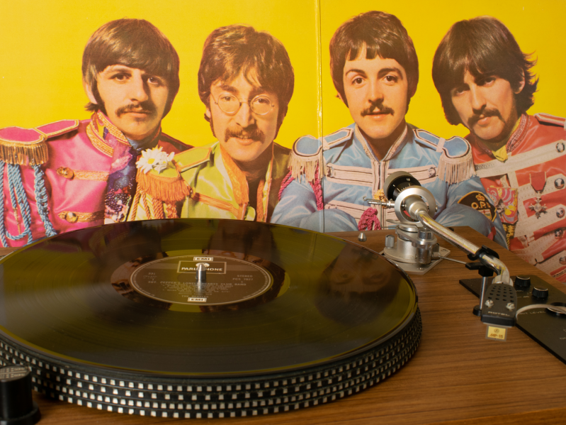 Playing Sgt Pepper's Lonely Hearts Club Band vinyl record by the Beatles on a direct drive record player. Inner cover with photograph of the Beatles