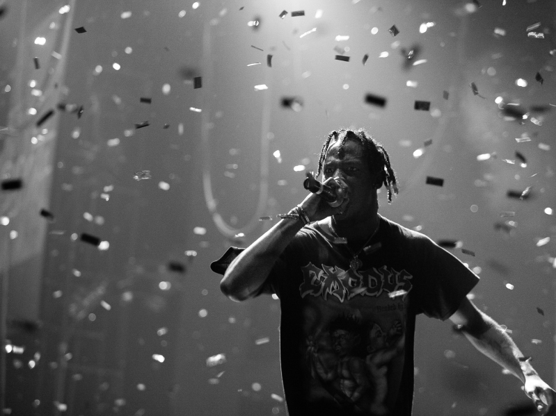 Travis Scott at a concert with glitter falling from the ceiling