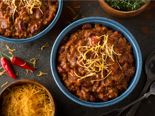 Bowls of chili and some cheese