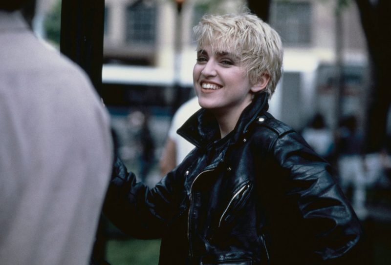 Madonna in 1986 rocking a black leather jacket and short blond pixie cut.