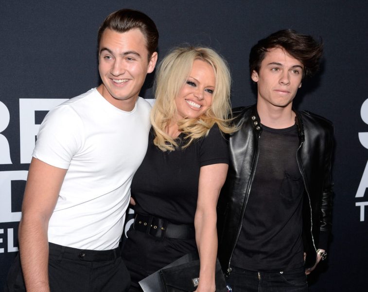 LOS ANGELES, CA - FEBRUARY 10: Actress Pamela Anderson (center) and her sons Brandon Lee (L) and Dylan Lee attend the Saint Laurent show at The Hollywood Palladium on February 10, 2016 in Los Angeles, California.