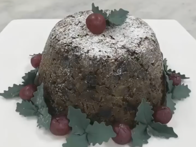 The royal family's christmas pudding surrounded by leaves and berries
