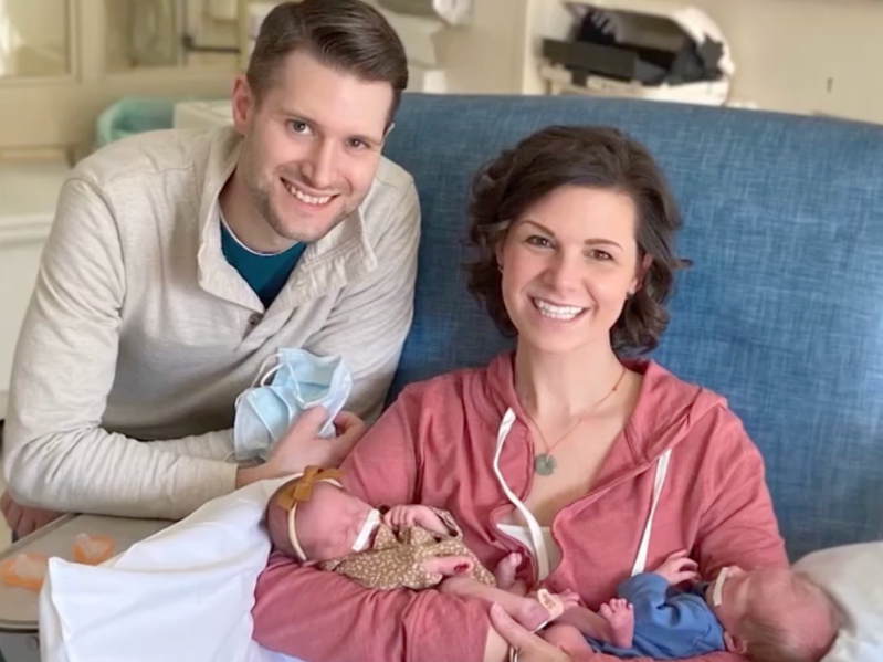 Tammy and Jordan Myers holding their twins Eames and Ellison