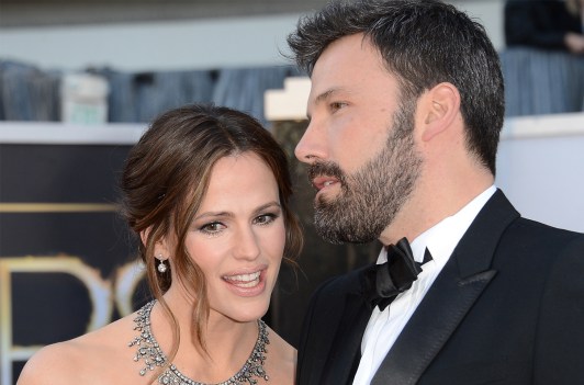 Ben Affleck on the right, whispering something to Jennifer Garner at a red carpet event.